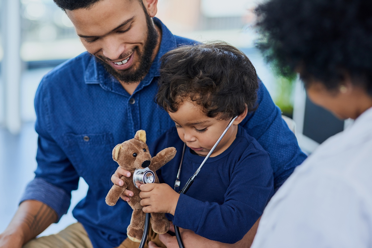 Shot of a single father bringing his little boy for a checkup